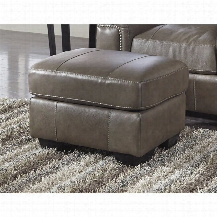 Ashley Donnell Leather Ottoman In Graniet