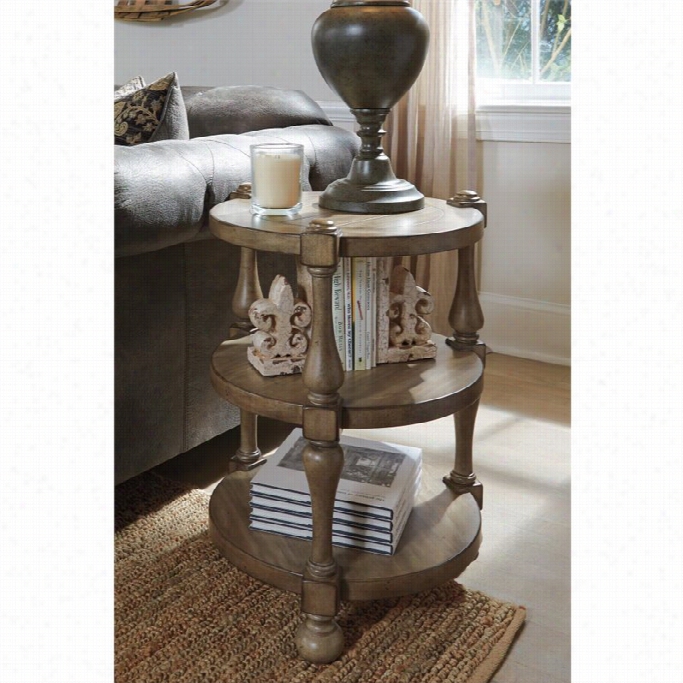 Ashley Chalimone Round Stress  End Table In Grayish Brown