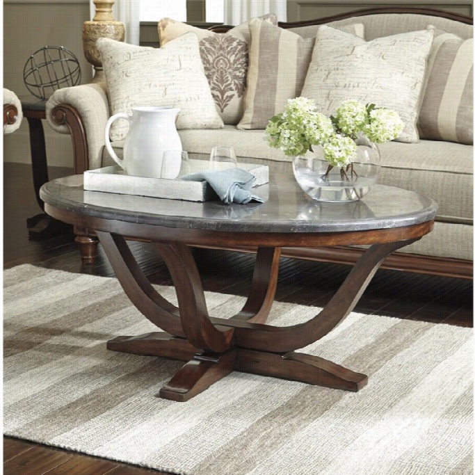 Ashley Balinder Oval Coffee Table In Medium Brown