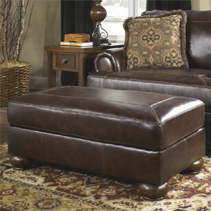 Ashley Furniture Axiom Leatr Ottmoan In Walnut